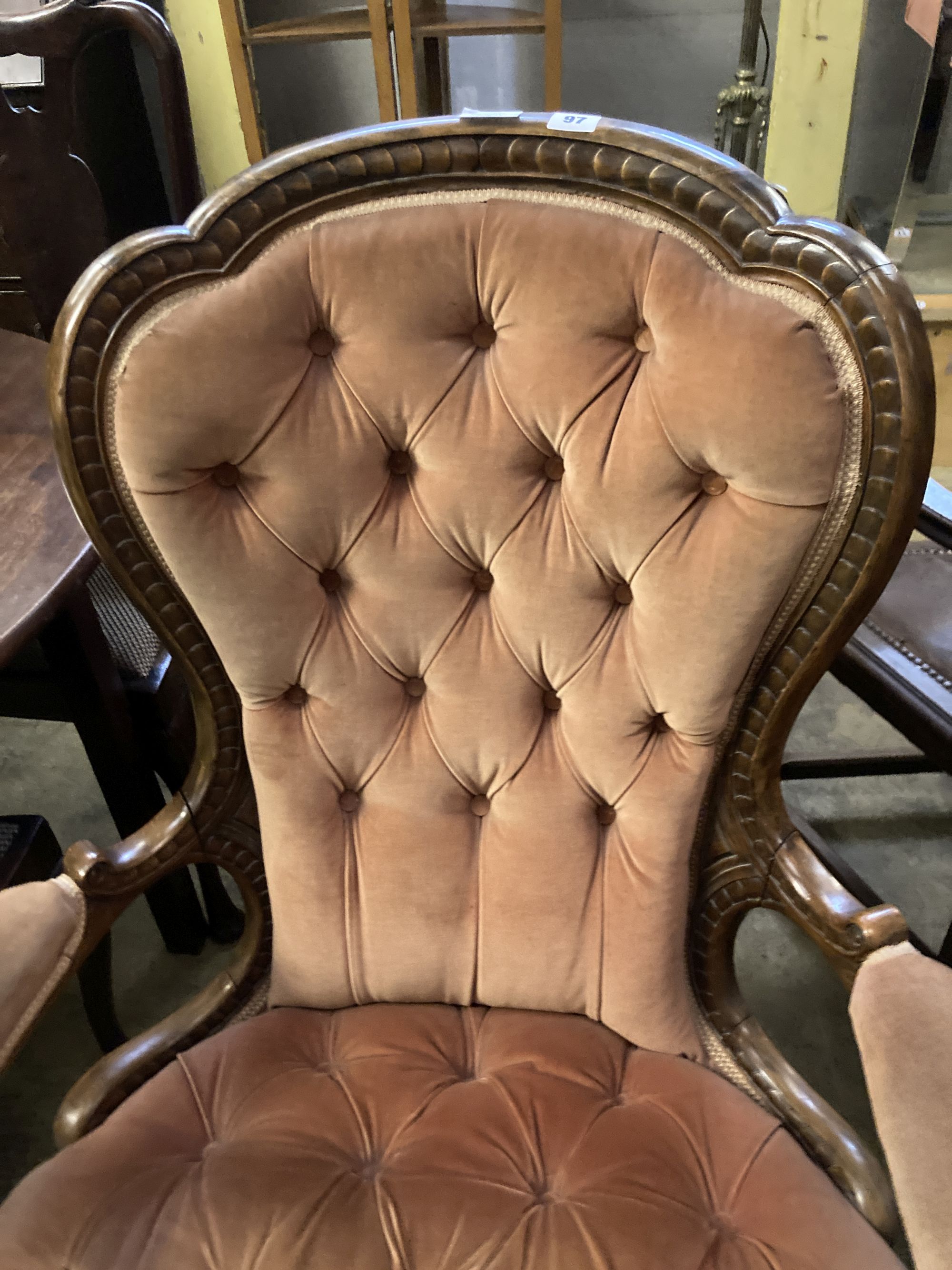 A Victorian carved walnut upholstered spoon back armchair, width 75cm, depth 70cm, height 102cm